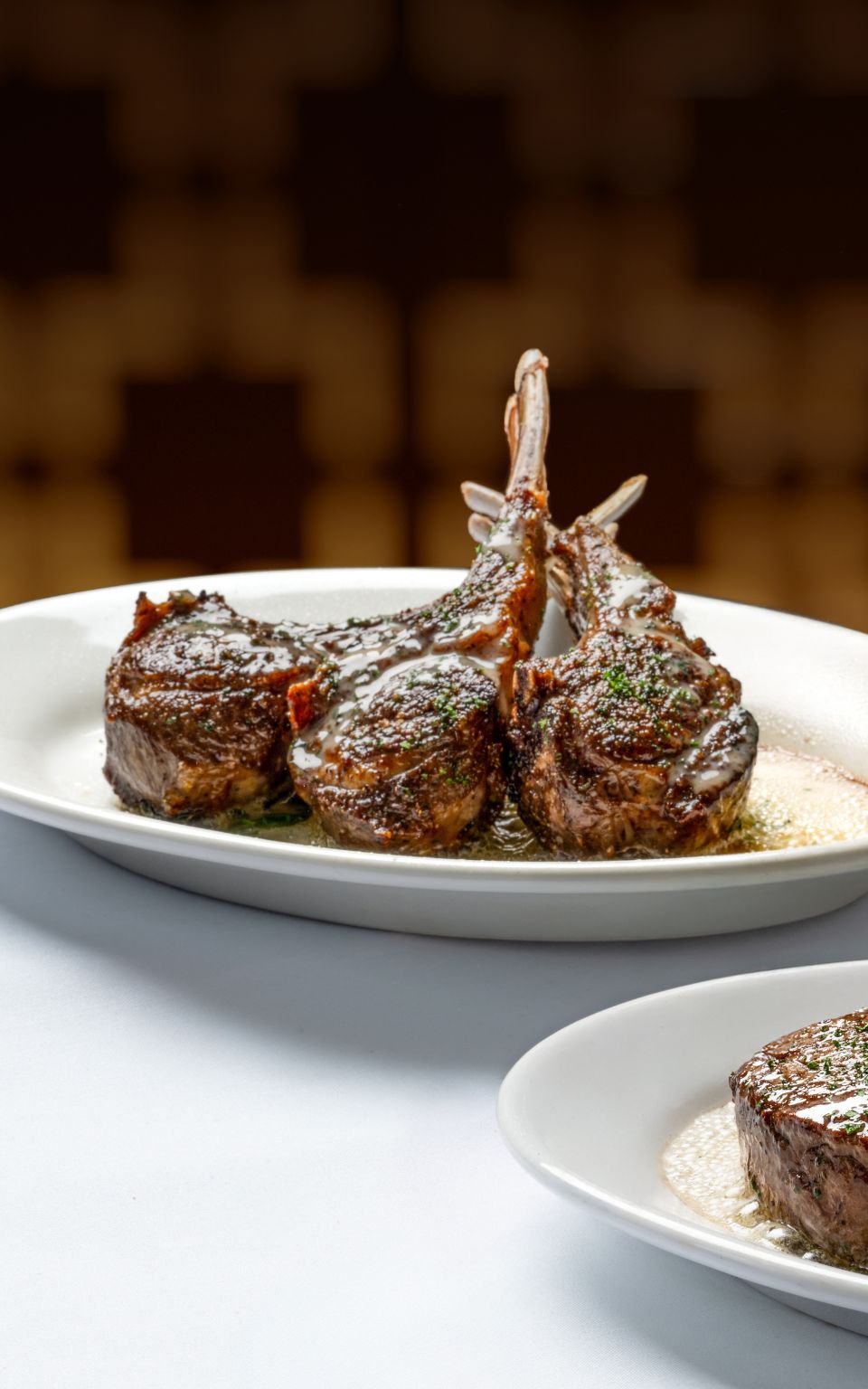 Ruth's Chris' Chef's Spring Selection featuring tender 8 oz center-cut filet paired with three blackened scallops served atop a medley of corn and spinach