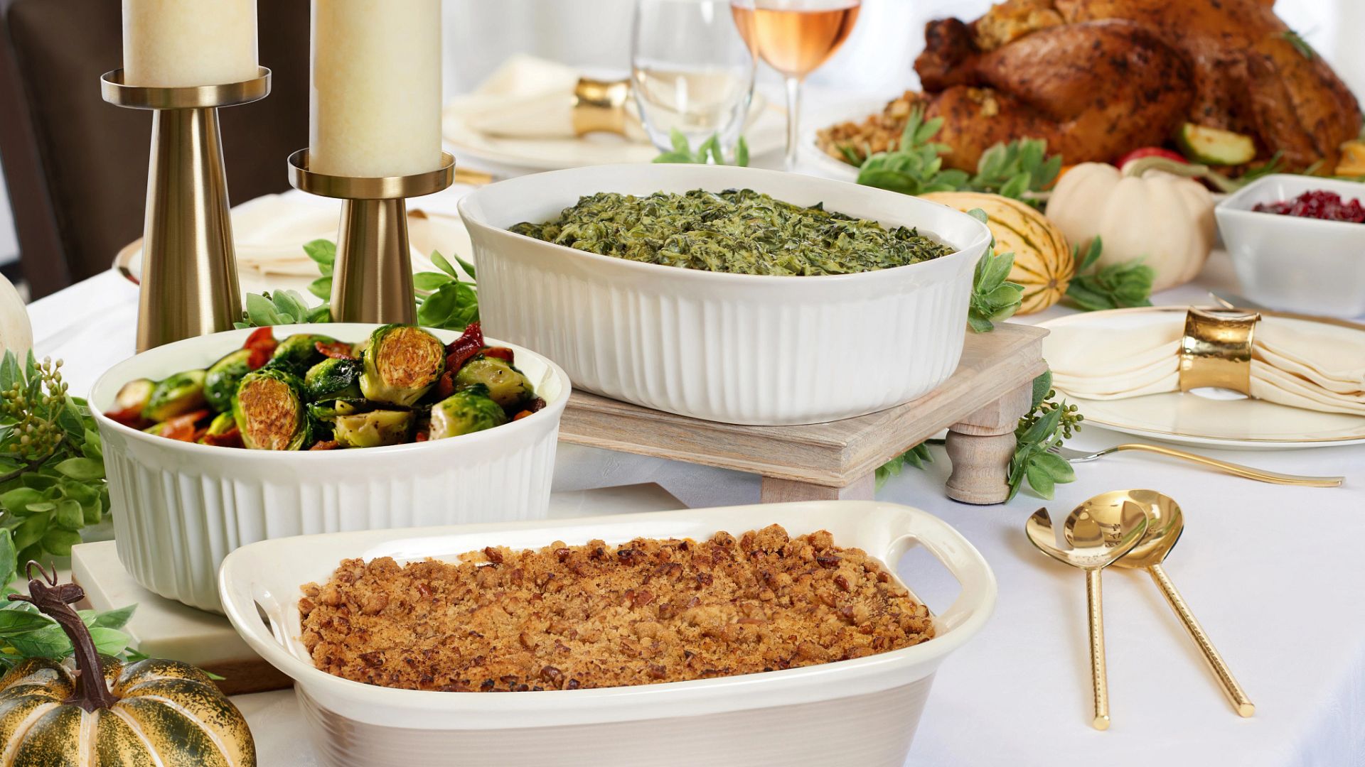 Ruth’s Chris Holiday Reheating Instructions. Table with a turkey, spinach, brussel sprouts and stuffing.