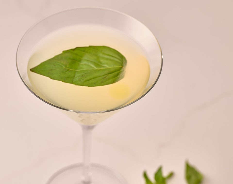 Ruth's Chris CHEF’S Summer Cocktail Selection: CUCUMBER GIN MARTINI. a twist on a classic—hendrick’s gin, lime, cucumber agave, garnished with a fresh basil leaf.