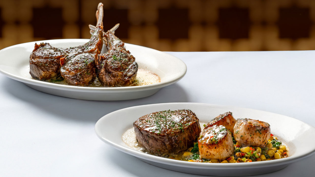 Image of a tender Ruth's Chris 8 oz center-cut filet paired with three blackened scallops served atop a medley of corn and spinach.