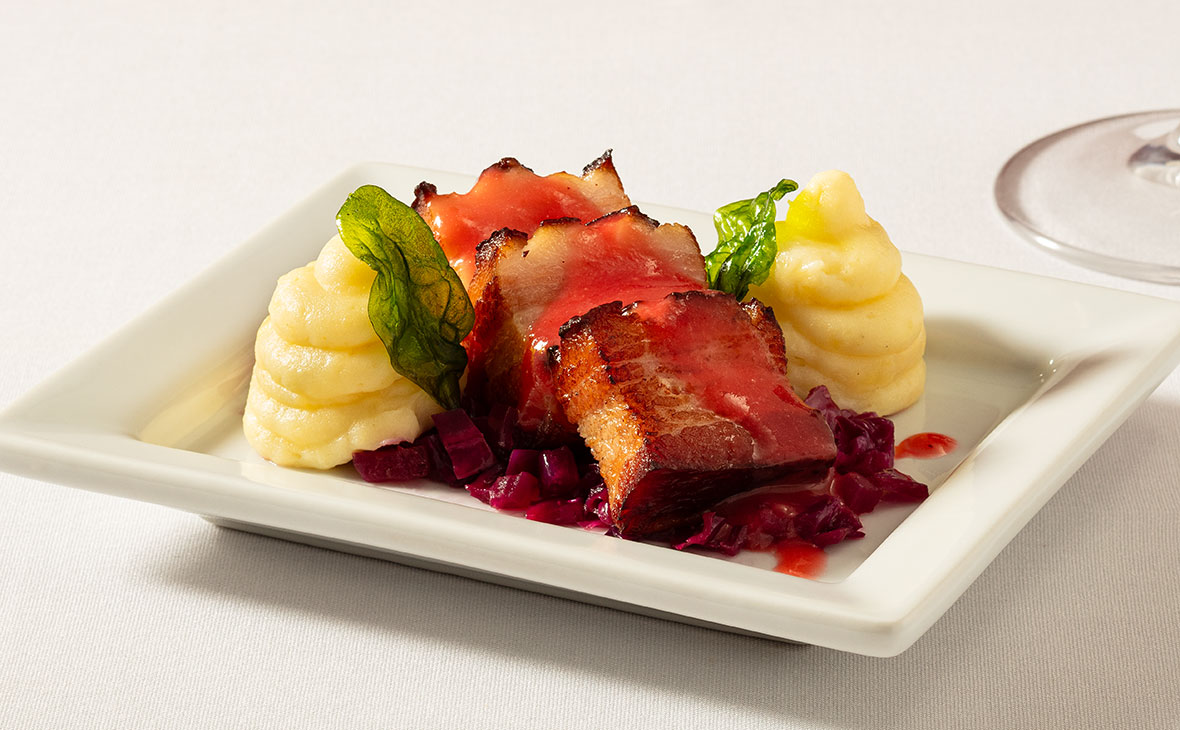 Ruth's Chris Thick cut Neske Bacon served over a crisp red cabbage and apple slaw.